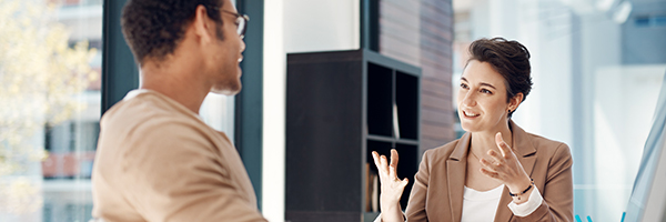 Mentor, training and a woman manager with an employee in the office for coaching on company vision. Management, meeting and a female business person talking to a professional male colleague at work.